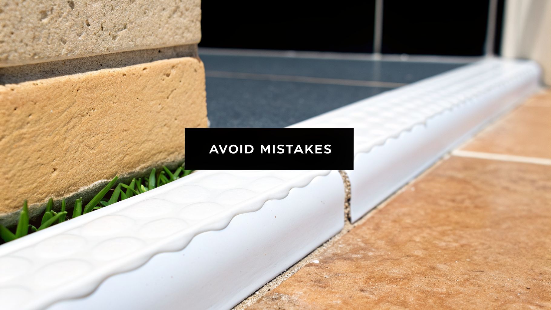 Detail of white caulking sealant applied along a brick wall, green grass, and outdoor tiles, with text 'AVOID MISTAKES'.