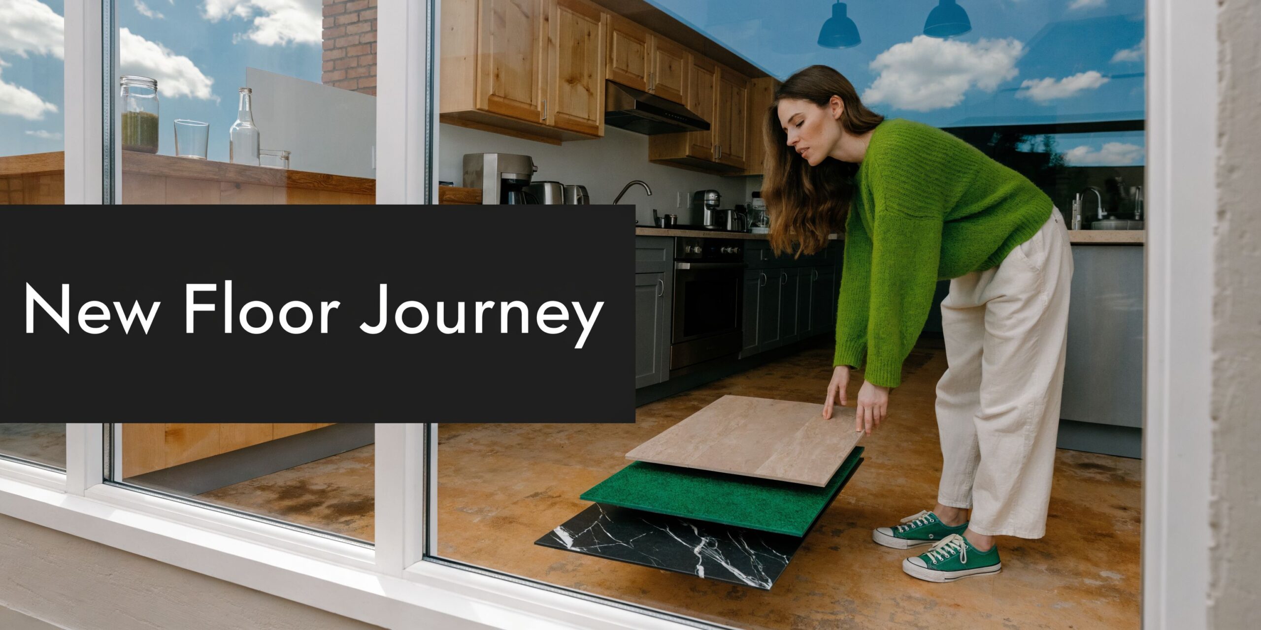 A woman holding sample flooring boards while choosing materials for her home renovation project in a kitchen.