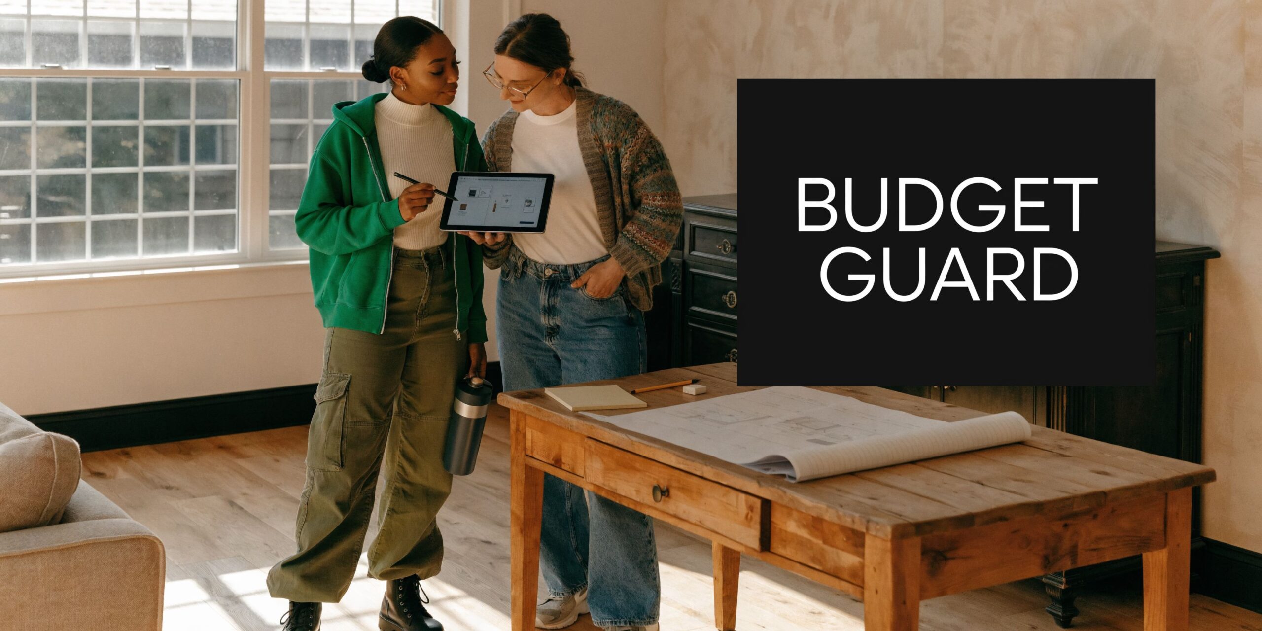 Two women collaborating on a home renovation project while reviewing floor plans on a digital tablet screen.