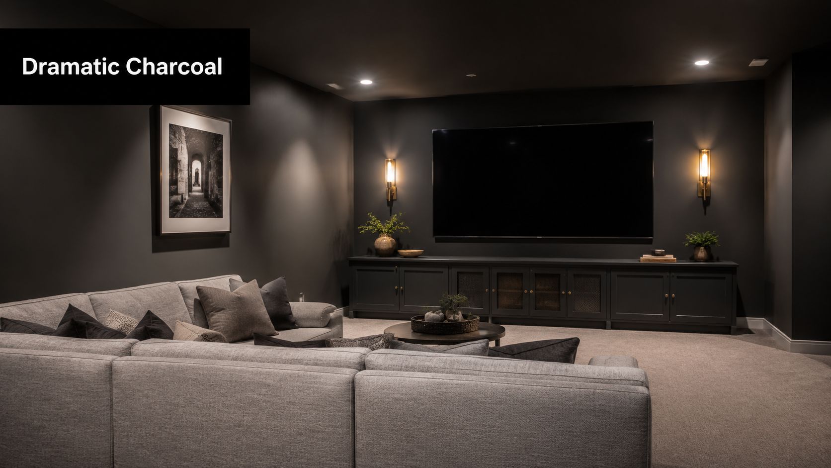 A modern basement home theater featuring dark charcoal walls, a large television, and a comfortable gray sectional sofa.